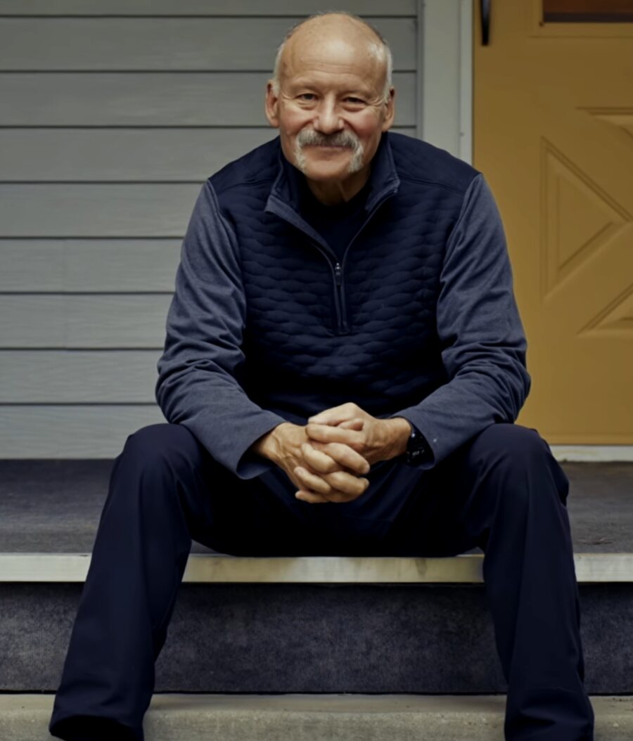 A Moneta member sitting on his front steps at home